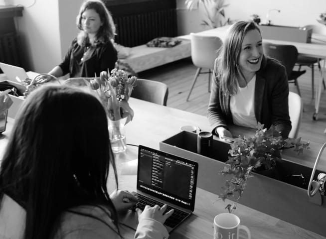 photo of women at a table working